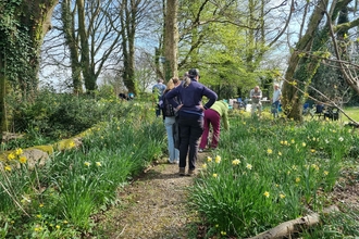A group of people walking through a garden
